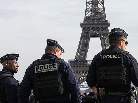 Police officers patrol the Trocadero plaza near the Eiffel Tower in Paris, Tuesday, Oct. 17, 2023. 