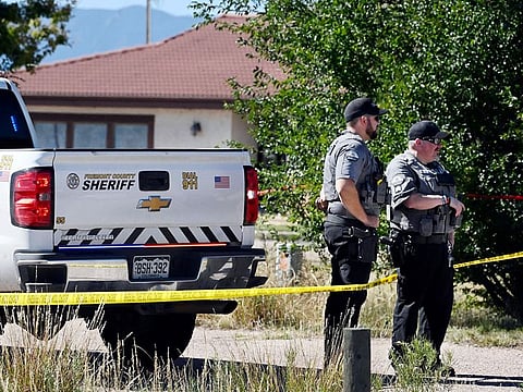 Fremont County deputies guard the road leading to the Return to Nature Funeral Home in Penrose, Colo. Thursday, Oct. 5, 2023. 