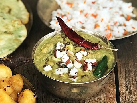 Narkel diye Cholar Dal or tempered lentils with fried coconut chips and raisins
