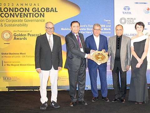 Eugene Mayne, second from right, receives the award from Sir Alok Sharma (centre) and Surinder Nath (second left)