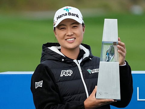Minjee Lee of Australia celebrates with the trophy after winning the BMW Ladies Championship at the Seowon Hills Country Club in Paju, South Korea, on Sunday.