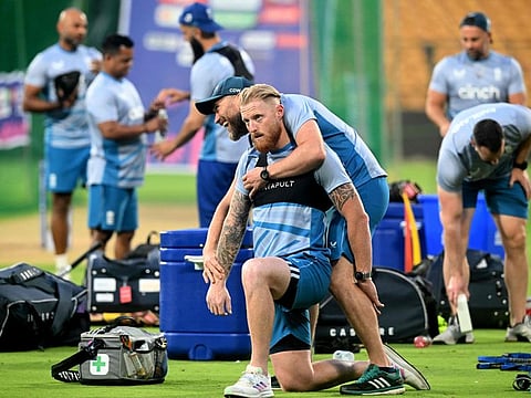England's Ben Stokes is assisted as he streches during a practice session at the M. Chinnaswamy Stadium in Bengaluru on Tuesday.