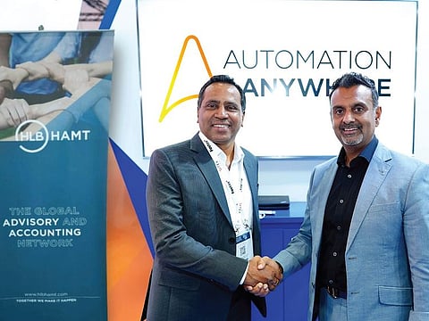 John Varghese, Managing Partner of HLB HAMT, and Raj Mistry, Executive VP - Sales and General Manager of Automation Anywhere EMEA, after signing an agreement in Dubai recently to make HLB Hamt a Centre of Excellence in intelligent automation and AI