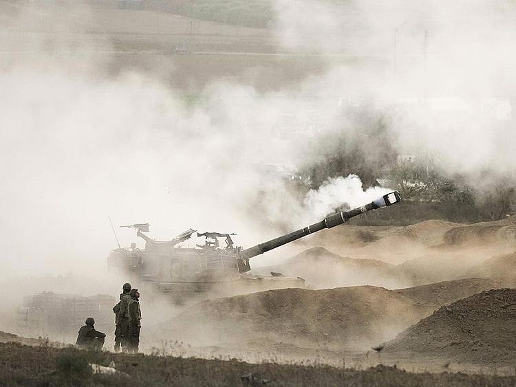 An Israeli mobile artillery unit fires a shell from southern Israel towards the Gaza Strip, in a position near the Israel-Gaza border, on Wednesday, October 25, 2023. 