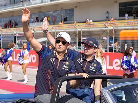 Red Bull drivers Sergio Perez (left) and Max Verstappen wave during the drivers parade in the US Grand Prix at Circuit of the Americas.
