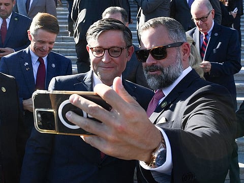 Newly elected US House Speaker Mike Johnson poses for a selfie with other House Republicans shortly after being elected Speaker outside the US Capitol in Washington, DC, on October 25, 2023. Republicans on October 24 made their fourth pick in just two weeks to replace the ousted speaker of the US House of Representatives, underlining the chaos engulfing the fragmented party after three previous nominees failed to win the gavel. 