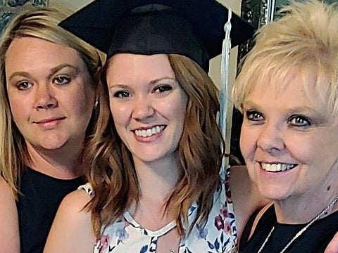 File photo: Brianna Hayes, centre, poses with her older sister Darci Hayes, left, and mother Sharon Hayes, right, in June 2019 after graduating from her graduate school program at Eastern Washington University in Cheney, Washington.  