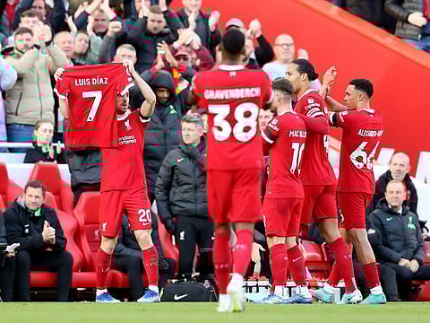 Liverpool's Diogo Jota is applauded by teammates while holding up a shirt in support of Liverpool's Luis Diaz at Anfield on Sunday.