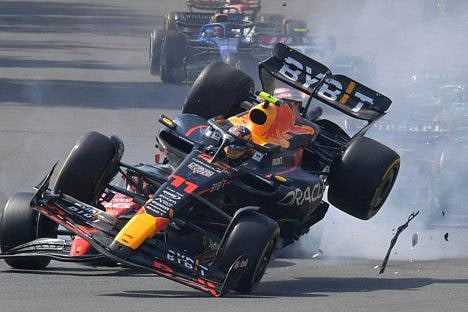 Red Bull Racing's Mexican driver Sergio Perez crashes with Ferrari's Monegasque driver Charles Leclerc  at the start of the Mexico Grand Prix at the Hermanos Rodriguez racetrack in Mexico City on Sunday.