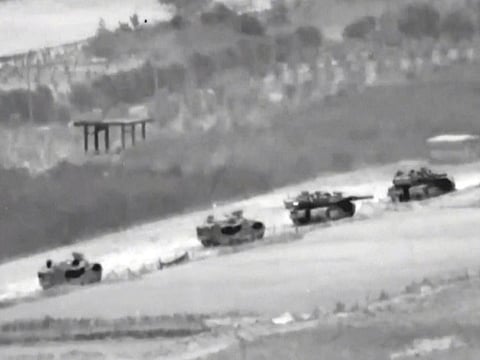 A line of Israeli tanks are shown during an incursion into the Gaza Strip.  