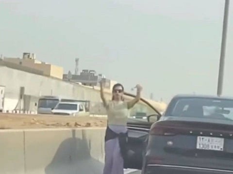 A video circulating on social media shows a woman standing next to a car with an open door and dancing to recorded music.