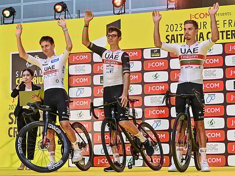 UAE-Team Emirates team members (left to right) Tadej Pogacar of Slovenia, Davide Formolo of Italy and Ivo Oliveira of Portugal wave to the crowd during an event a day ahead of the Tour de France Saitama Criterium race in Saitama on Sunday.