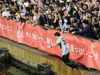 Japan baseball fans leap into river as 'Curse of the Colonel' lifted