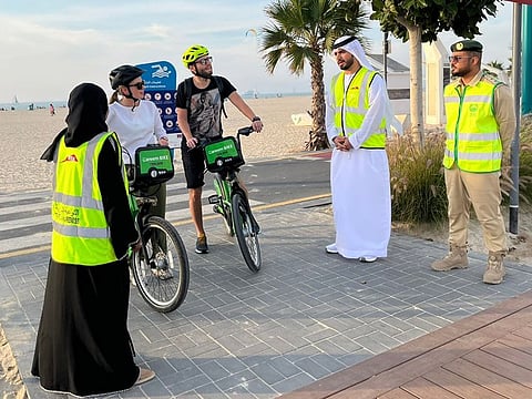 Representatives from RTA and Dubai Police interacting with cyclists during the campaign