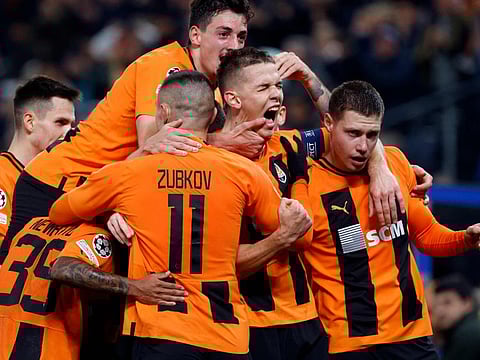 Shakhtar Donetsk's players celebrate the opening goal by Ukrainian forward Danylo Sikan (second right) during the Champions League Group H match against FC Barcelona in Hamburg on Tuesday.