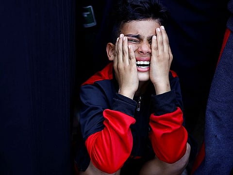 Emad Al Salot's son reacts, as he mourns his father who was killed in Israeli strikes, amid the ongoing Gaza conflict, at a hospital, in Khan Younis in the southern Gaza Strip, November 8, 2023