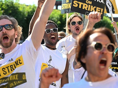 SAG-AFTRA members and supporters picket outside Paramount Studios during their strike against the Hollywood studios, in Los Angeles, California.