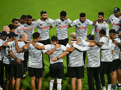 Sri Lanka's players gather during a practice session on the eve of their Cricket World Cup match against New Zealand at the M. Chinnaswamy Stadium in Bengaluru.