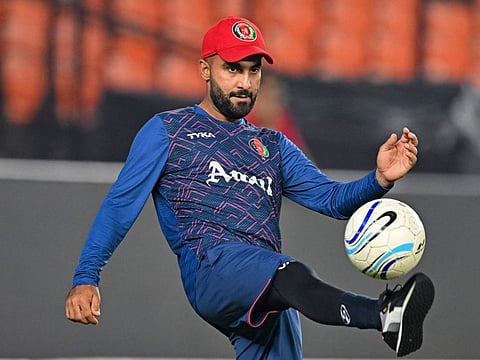 Afghanistan's captain Hashmatullah Shahidi plays football during a practice session on the eve of their Cricket World Cup match against South Africa at the Narendra Modi Stadium in Ahmedabad on Thursday.