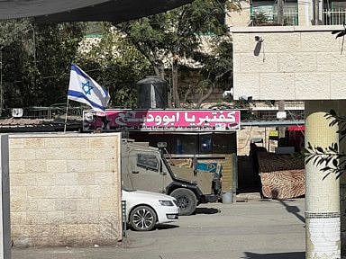 An Israeli army vehicle is seen in front of a hospital during an Israeli raid in Jenin on November 9,2023.  
