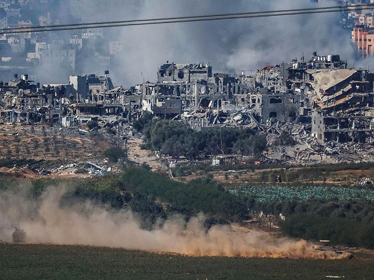An Israeli tank maneuvers in Gaza while smoke rises as seen from Southern Israel, amid the ongoing conflict between Israel and the Palestinian group Hamas, November 11, 2023. 