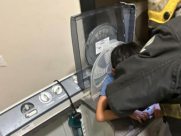 Boy stuck inside washing machine