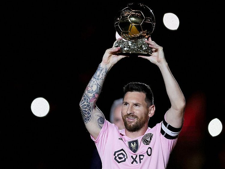 Lionel Messi of Inter Miami CF hoist his trophy during the Ballon d'Or trophy presentation 