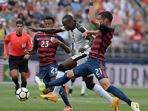 United States' Kellyn Acosta, left, and Matt Hedges, right, pressure Ghana's Raphael Dwamena, center, during the first half of an international friendly soccer match at Pratt & Whitney Stadium at Rentschler Field, Saturday, July 1, 2017, in East Hartford, Conn. Former Ghana striker Raphael Dwamena has died after collapsing on Nov. 11, 2023, during an Albanian Super League soccer match. 