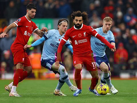 Liverpool's Mohamed Salah and Dominik Szoboszlai in action with Brentford's Mathias Jensen and Ben Mee during a Premier League match at Anfield on Sunday.