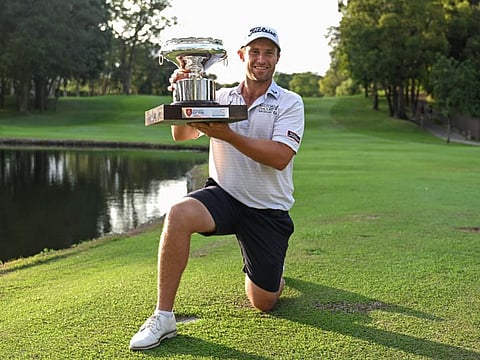 New Zealand's Ben Campbell celebrates with the trophy after his victory on the final day of the Hong Kong Open at Fanling golf club in Hong Kong on Sunday.