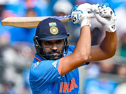 India’s captain Rohit Sharma watches the ball after playing a shot during the 2023 ICC Men's Cricket World Cup semifinal match against New Zealand at the Wankhede Stadium in Mumbai, India, on November 15, 2023. 