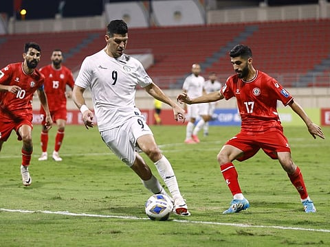 Palestine's Tamer Seyam in action with Lebanon's Ali Al Haj during the World Cup AFC Qualifiers at Khalid Bin Mohammed Stadium, Sharjah on Thursday.