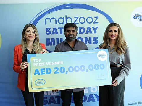 Suzan Kazzi, Head of Communications and CSR, Mahzooz, left, with Dh20 million winner Sreeju and presenter Aishwarya Ajit.