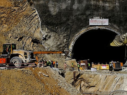 Heavy machinery moves outside a tunnel where 40 road workers are trapped after a portion of the tunnel collapsed in Uttarkashi in the northern state of Uttarakhand, India, November 16, 2023. 