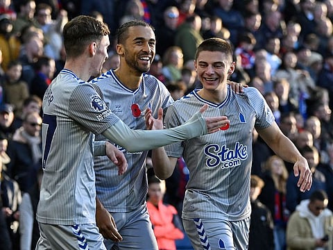Everton's Vitaliy Mykolenko celebrates with James Garner and Dominic Calvert-Lewin after scoring a goal against Crystal Palace.