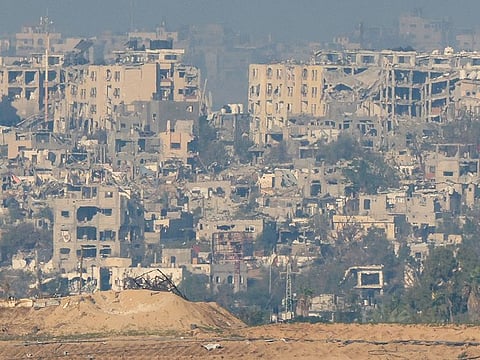 A picture taken from the border between Israel and Gaza shows buildings heavily destroyed  by Israeli strikes in the Gaza Strip, on November 17, 2023, amid the ongoing battles between Israel and the Palestinian militant group Hamas. 