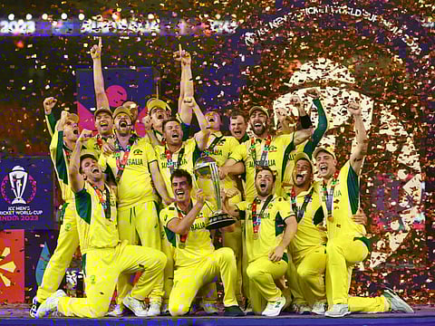 Australia players celebrate with the trophy after winning the Cricket World Cup.