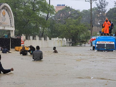 Passengers wade through flood waters after getting evacuated from a public transport bus, following heavy rains in Kisauni district of Mombasa.