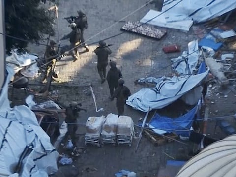 Israeli soldiers walk in the area of Al Shifa hospital in Gaza City.  