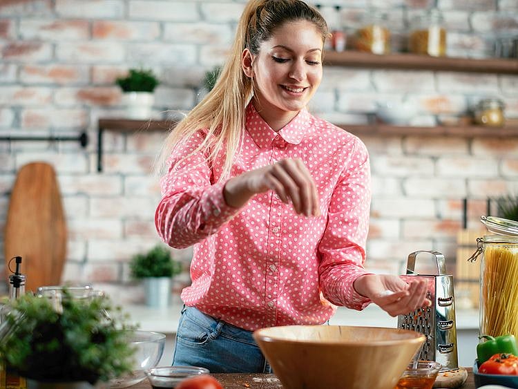 Woman putting salt