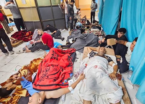 Palestinians wounded in Israeli strikes lie on the floor as they are assisted at the Indonesian hospital after Al Shifa hospital has gone out of service amid Israeli ground offensive, in the northern Gaza Strip.
