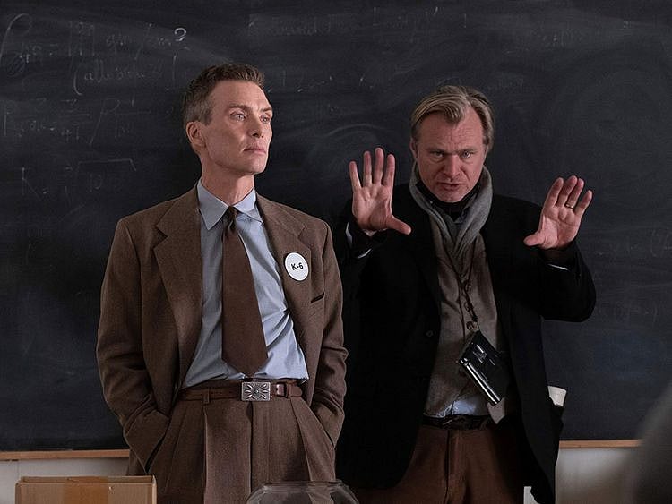 This image released by Universal Pictures shows writer-director-producer Christopher Nolan, right, and actor Cillian Murphy on the set of "Oppenheimer."