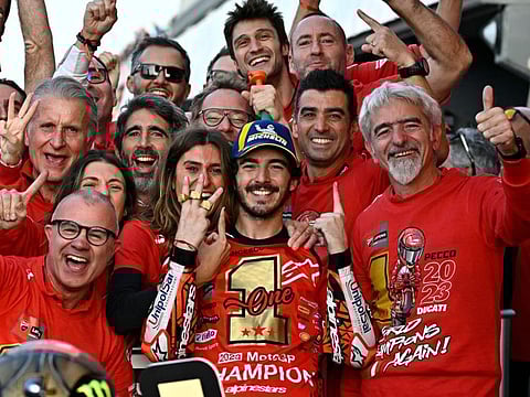 Ducati Italian rider Francesco Bagnaia (centre) and his partner Domizia Castagnini celebrate with the team after winning the MotoGP Valencia Grand Prix at the Ricardo Tormo racetrack in Cheste on Sunday.