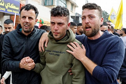 Men react as they attend a funeral of Shamikh Abualrob, Palestinian who was killed in an Israeli raid, in Qabatia near Jenin in the West Bank, November 25, 2023.  