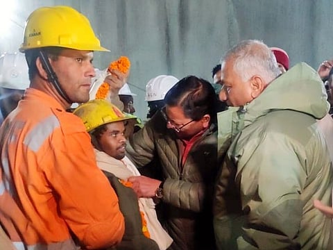 Uttarakhand CM Pushkar Singh Dhami and Union Minister VK Singh meet the worker who was trapped inside the Silkyara tunnel after the rescue operation, in Uttarkashi on Tuesday.