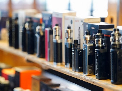 Vape pens stand in a display cabinet at a vape store, in Melbourne.