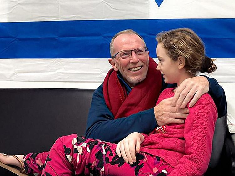 Nine-year-old Irish Israeli former hostage Emily Hand with her father at a hospital in Israel after being released by Hamas, amid an exchange operation of hostages against prisoners between Hamas and Israel, on November 26, 2023.  