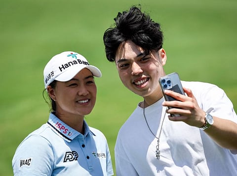 Australia's Minjee Lee (left) poses for a photograph with a fan after a practice round at the Australian Golf Club in Sydney.