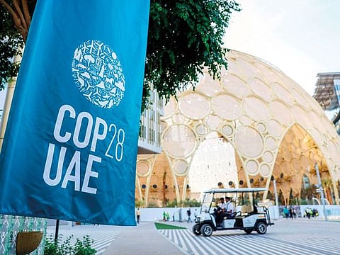 An event banner outside the Al Wasl dome in the Green Zone at the COP28 climate conference at Expo City Dubai.