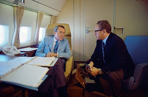 US President Richard Nixon and National Security Adviser Henry Kissinger speak on Air Force One during their voyage to China on February 20, 1972.  